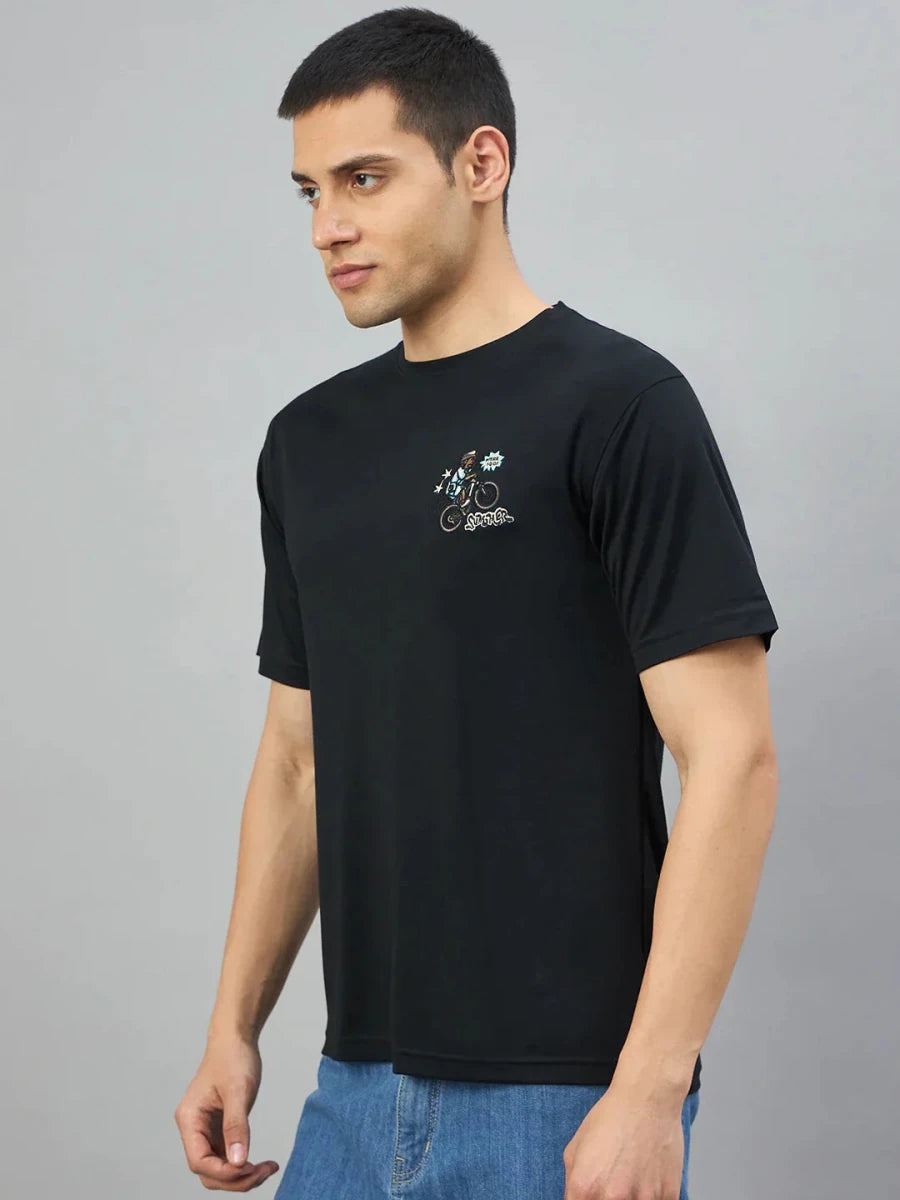 Man wearing 98degreenorth's black oversized graphic t-shirt with RockStar back print, standing sideways on grey background.