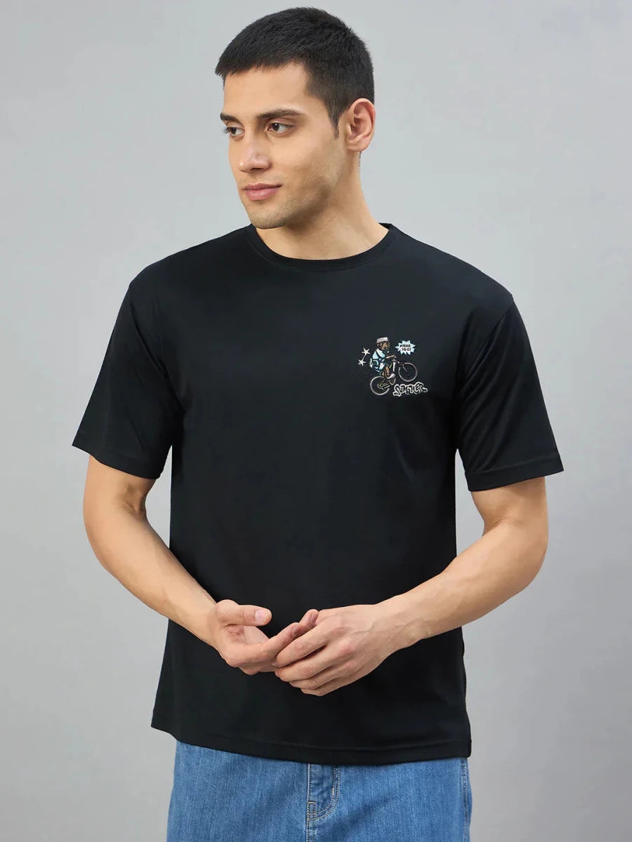 Man wearing 98degreenorth Men's Black Graphic Oversized T-Shirt with RockStar Back Print, on a plain gray background.
