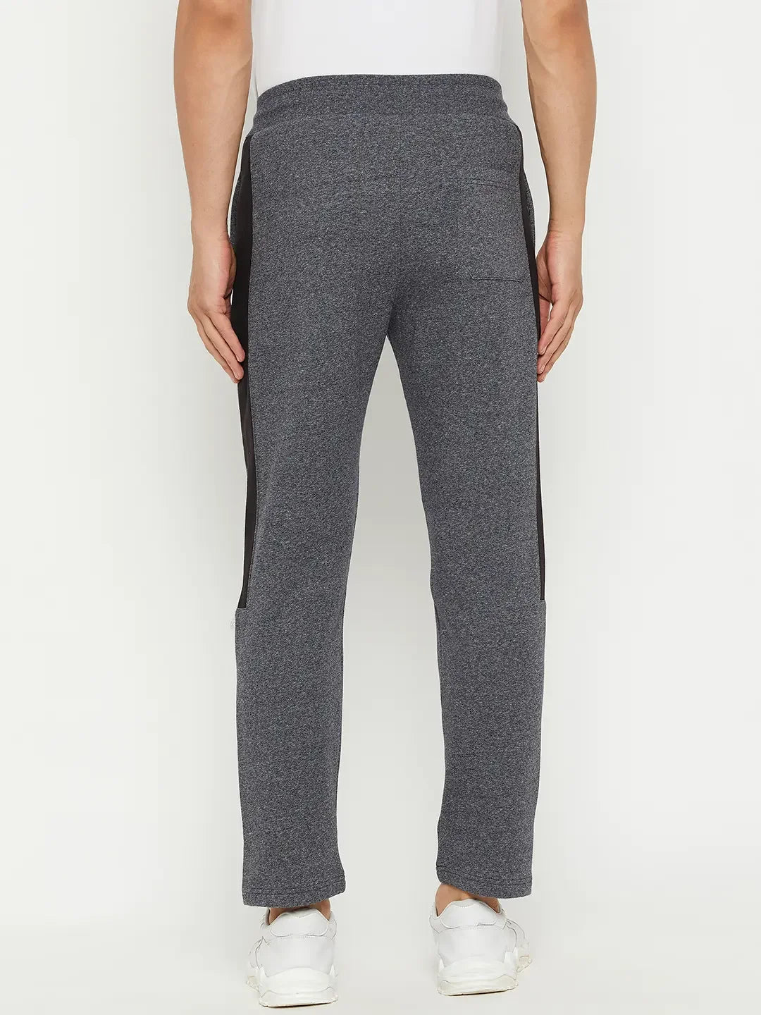 Man in 98degreenorth Black Jaspe Fleece Trackpants with side panel, seen from the back on a white background.
