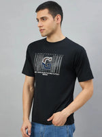 Man in a Men's Black Magnetic Graphic T-Shirt by 98degreenorth, ideal for bold streetwear style.