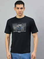 Man in a 98degreenorth Men's Black Magnetic Graphic T-Shirt, Cotton Lycra, against a plain gray background.