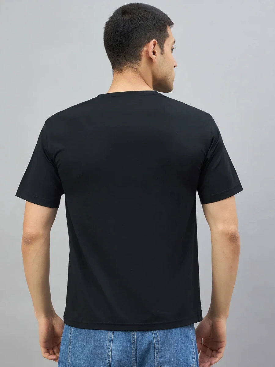 A man wears the 98degreenorth Men's Black Magnetic Graphic T-Shirt, standing with his back to the camera.