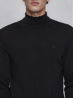 A man wears the 98degreenorth Men’s Black Merino Wool Turtle Neck Sweater, visible from shoulders to chin.
