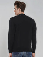 Man wears 98degreenorth Men’s Black Merino Wool Turtle Neck Sweater, facing away against a light background.