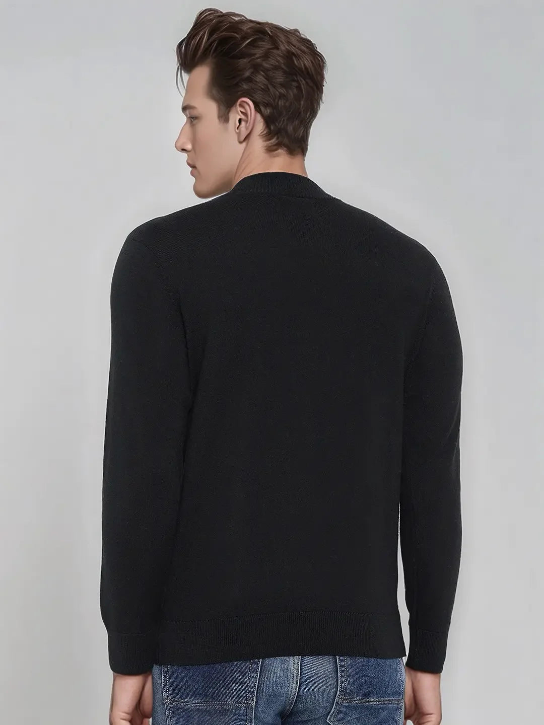 Man wears 98degreenorth Men’s Black Merino Wool Turtle Neck Sweater, facing away against a light background.