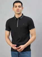 Man in 98degreenorth Men's Black Polo T-Shirt — Handmade Series, featuring contrast tipping, against grey background.