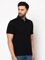 Man wears 98degreenorth Men's Black Polo T-Shirt—Stretch Cotton Pique Knit, styled with blue jeans, against white background.