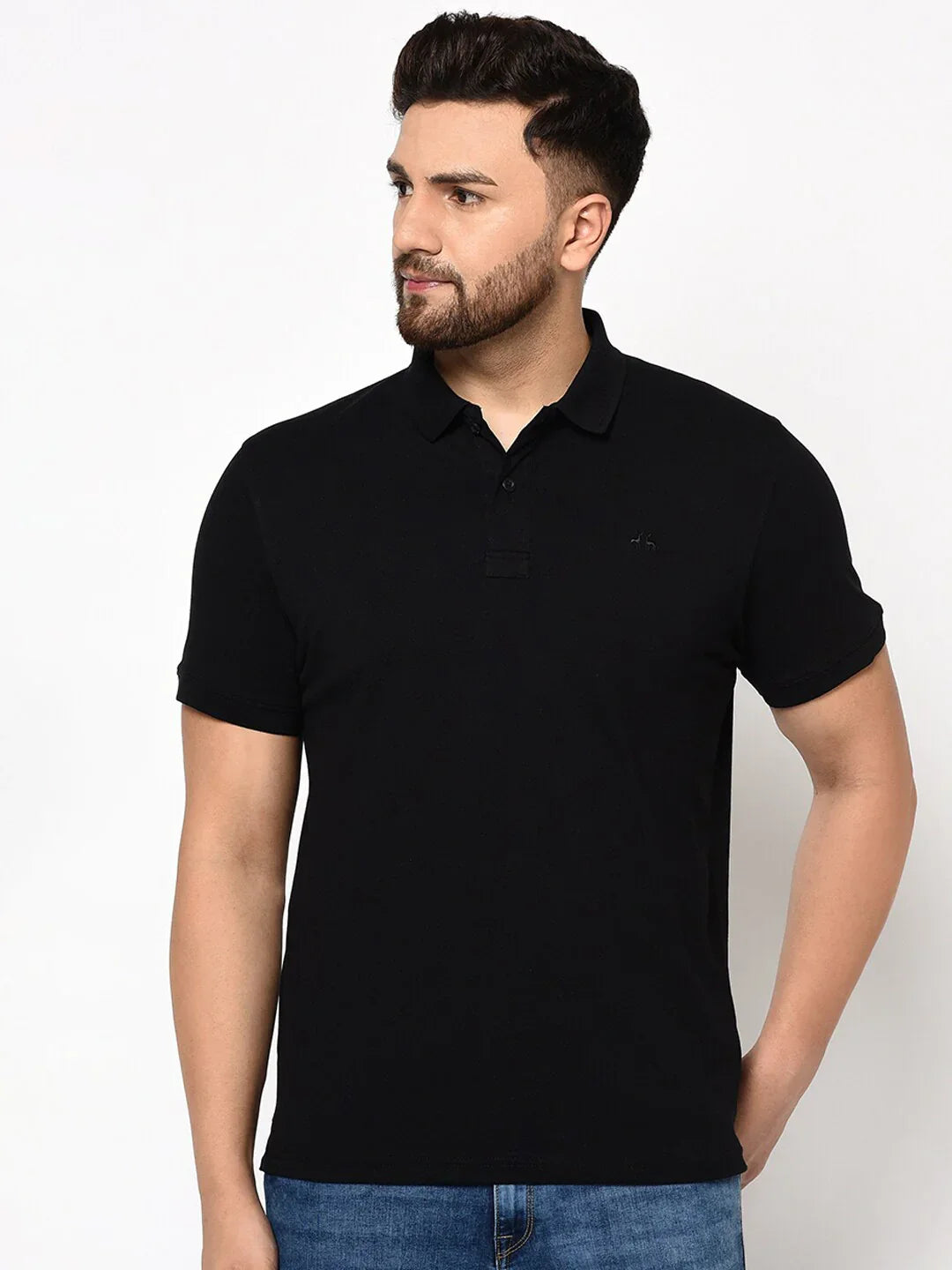 Man wears 98degreenorth Men's Black Polo T-Shirt — Stretch Cotton Pique Knit, paired with blue jeans.