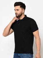 Man with short dark hair and beard wears 98degreenorth black stretch cotton pique polo with chest pocket and blue jeans.