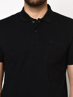 Man in 98degreenorth Men's Black Polo T-Shirt—Stretch Cotton Pique with Chest Pocket, shown shoulders to waist.