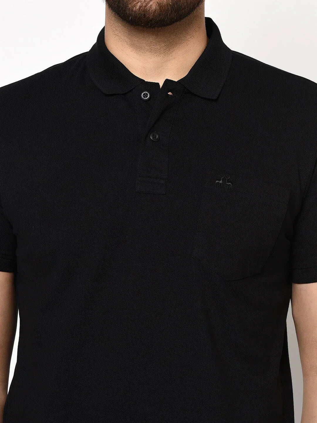 Man in 98degreenorth Men's Black Polo T-Shirt—Stretch Cotton Pique with Chest Pocket, shown shoulders to waist.