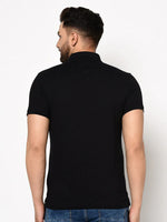 Man wearing 98degreenorth Men's Black Polo T-Shirt in stretch cotton pique with chest pocket, facing away.