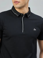 Man in 98degreenorth Men's Black Polo T-Shirt with White Tipping and LA Logo, crafted from premium cotton.