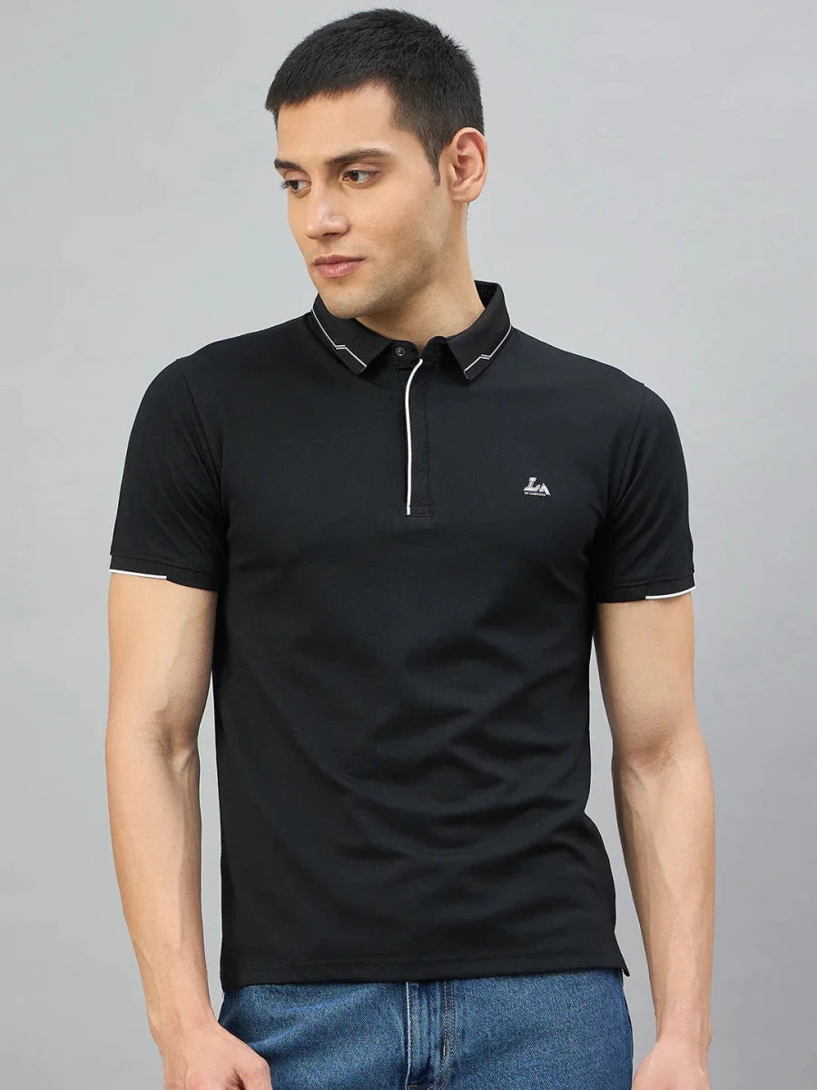 Man in 98degreenorth Men's Black Polo T-Shirt with White Tipping and LA logo, paired with blue jeans.