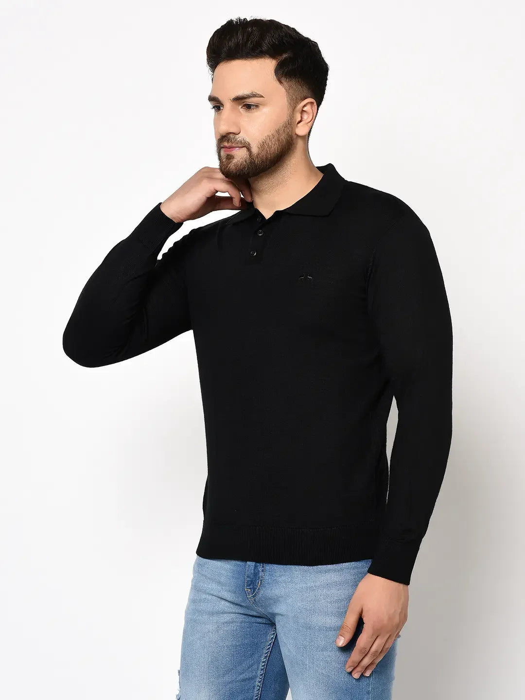 Man in a 98degreenorth Men’s Black Premium Merino Wool Polo Neck Sweater and blue jeans against a white background.