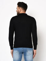 A man wears a 98degreenorth Men’s Black Premium Merino Wool Polo Neck Sweater and light blue jeans, back to camera.