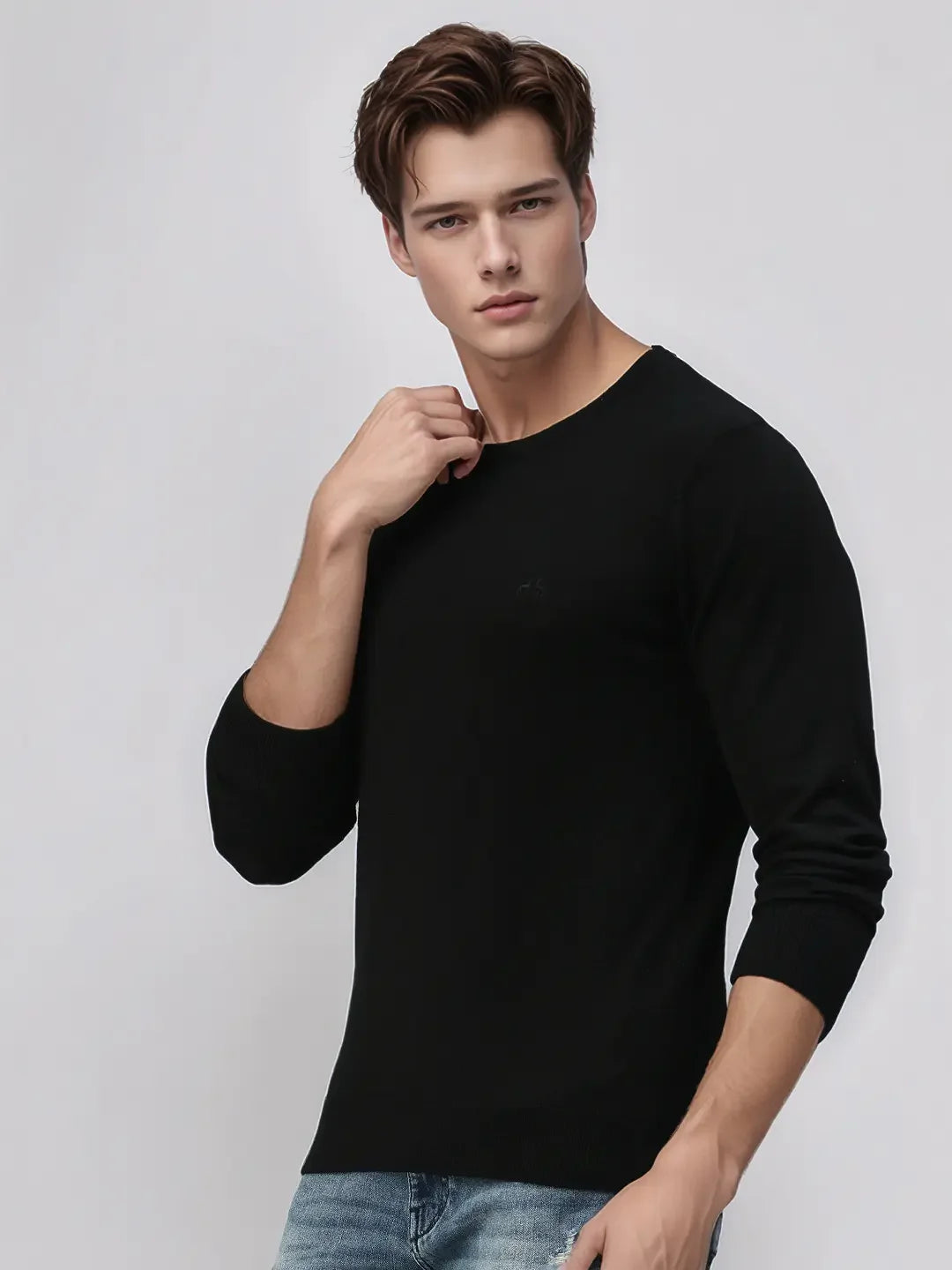 A man wears the 98degreenorth Men’s Black Premium Merino Wool Sweater, a luxury handcrafted knit pullover.