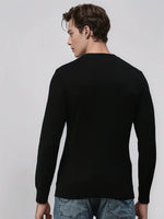 Man in 98degreenorth Men’s Black Merino Wool Sweater, handcrafted luxury knit, standing with back to camera.