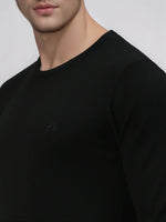 Man in 98degreenorth Men’s Black Premium Merino Wool Sweater, shown shoulder to mid-chest against light background.