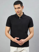 Man wearing the 98degreenorth Men's Black Quarter Zip Polo T-Shirt, Popcorn Knit, against a plain gray background.