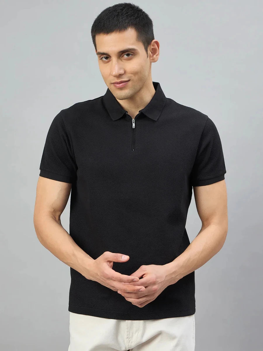 Man wearing the 98degreenorth Men's Black Quarter Zip Polo T-Shirt, Popcorn Knit, against a plain gray background.