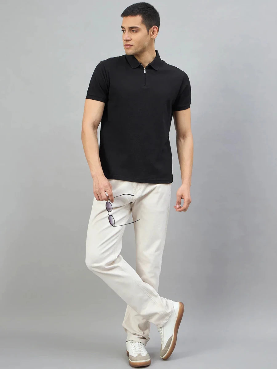 Man in 98degreenorth Men's Black Quarter Zip Polo T-Shirt, standing against a plain gray background.