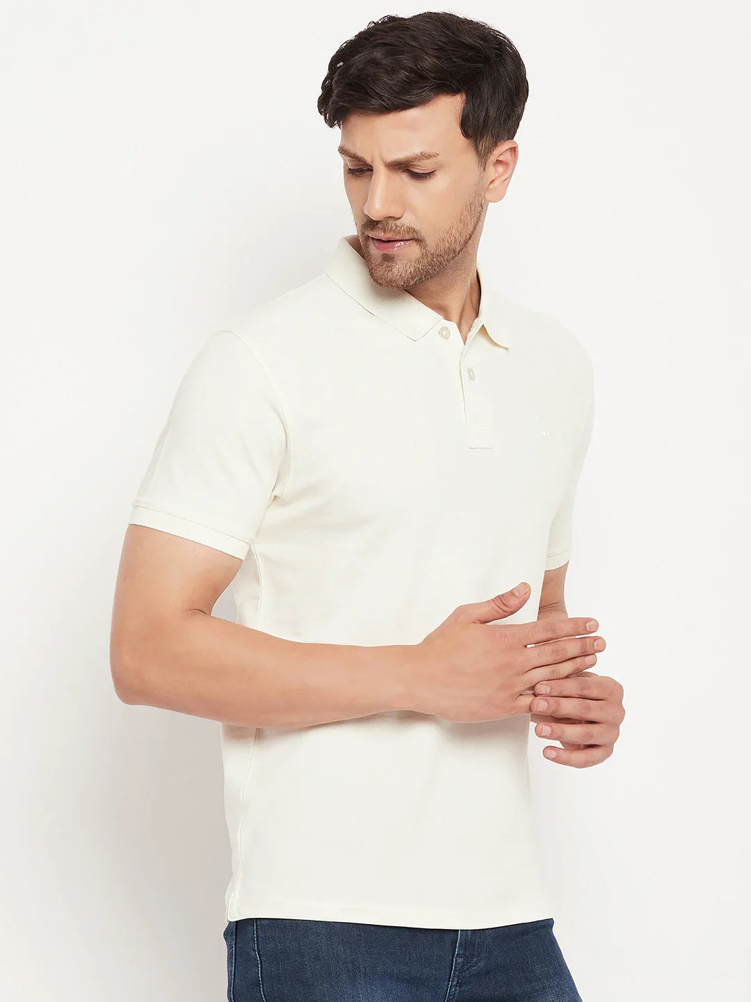 Man in a 98degreenorth men's butter yellow vertical striped polo tee, looking down left against a white background.