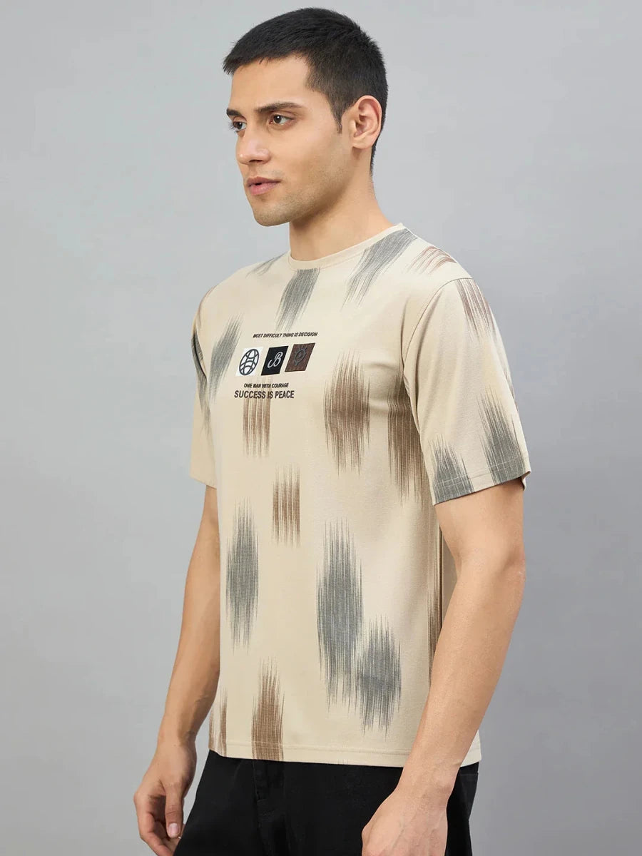 Man in a Men's Camel Abstract Ikat Print T-Shirt by 98degreenorth, standing sideways against a grey background.