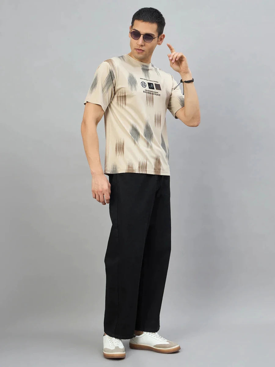 Man in streetwear—sunglasses, 98degreenorth Men’s Camel Abstract Ikat Print T-Shirt, black pants, and white sneakers.