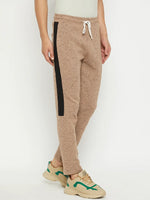 Man in 98degreenorth Men’s Camel Fleece Trackpants with Contrast Side Stripe, beige sneakers, white background.