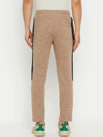 A person wears 98degreenorth Men’s Camel Fleece Trackpants with a black side stripe and sneakers, viewed from the back.