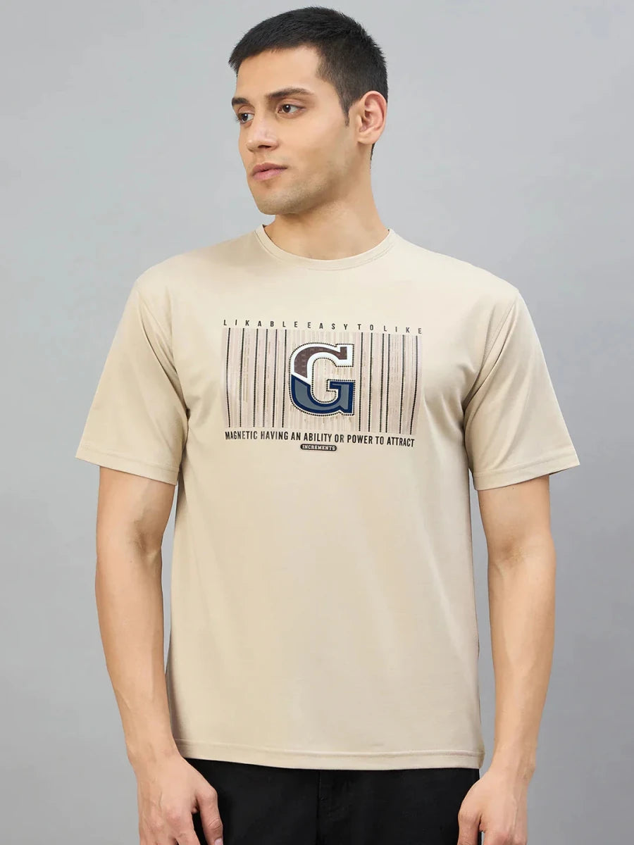 Man in 98degreenorth Men's Camel Graphic Oversized T-Shirt with Varsity G print, against a plain gray background.