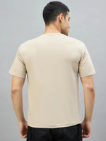 A man wears a 98degreenorth Men's Camel Graphic Oversized T-Shirt with Varsity G Print, shown from the back.