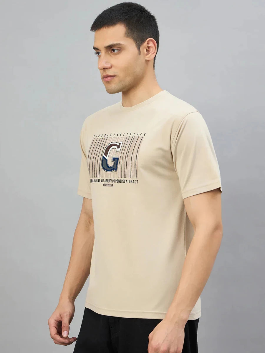Man in a 98degreenorth Men's Camel Graphic Oversized T-Shirt with Varsity G print, against a plain gray background.