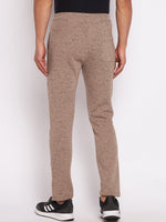 Model in 98degreenorth Men’s Camel Melange Fleece Trackpants and black sneakers, back view on white background.