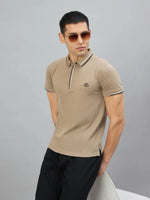 Man wears the 98degreenorth Handmade Series Men's Camel Polo T-Shirt with contrast tipping, hands behind his back.