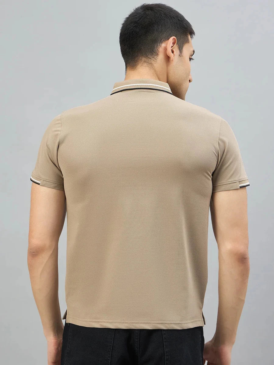 A man in a 98degreenorth Camel Polo T-Shirt | Handmade Series displays its premium cotton blend against a plain backdrop.