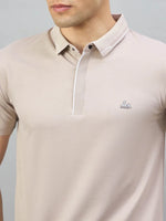 Man in 98degreenorth Men's Camel Polo T-Shirt with White Tipping and LA Logo on chest.