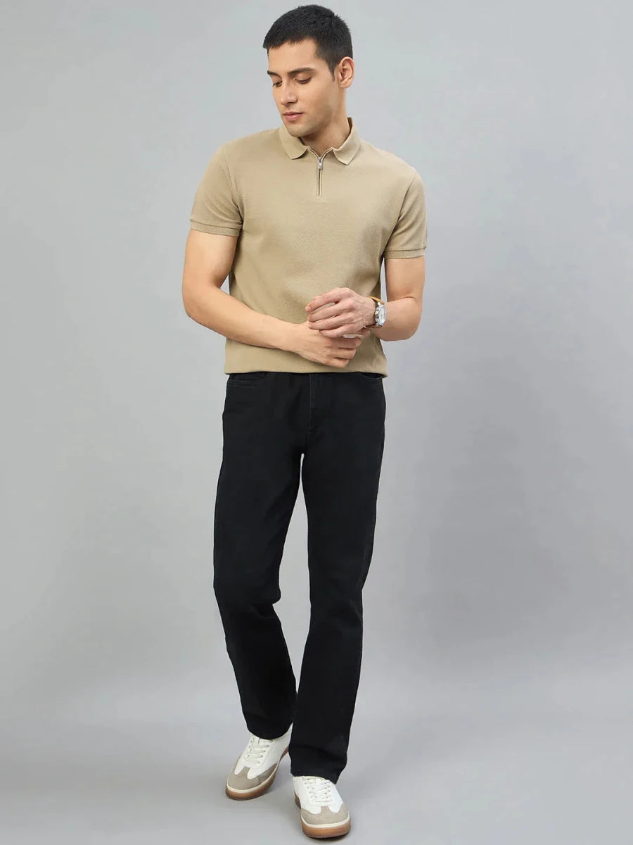 Man in a 98degreenorth Men's Camel Quarter Zip Polo T-Shirt, black pants, and white sneakers on a gray background.