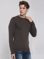 Young man wears 98degreenorth Men’s Charcoal Merino Wool Sweater, perfect for office or evening, against a gray backdrop.