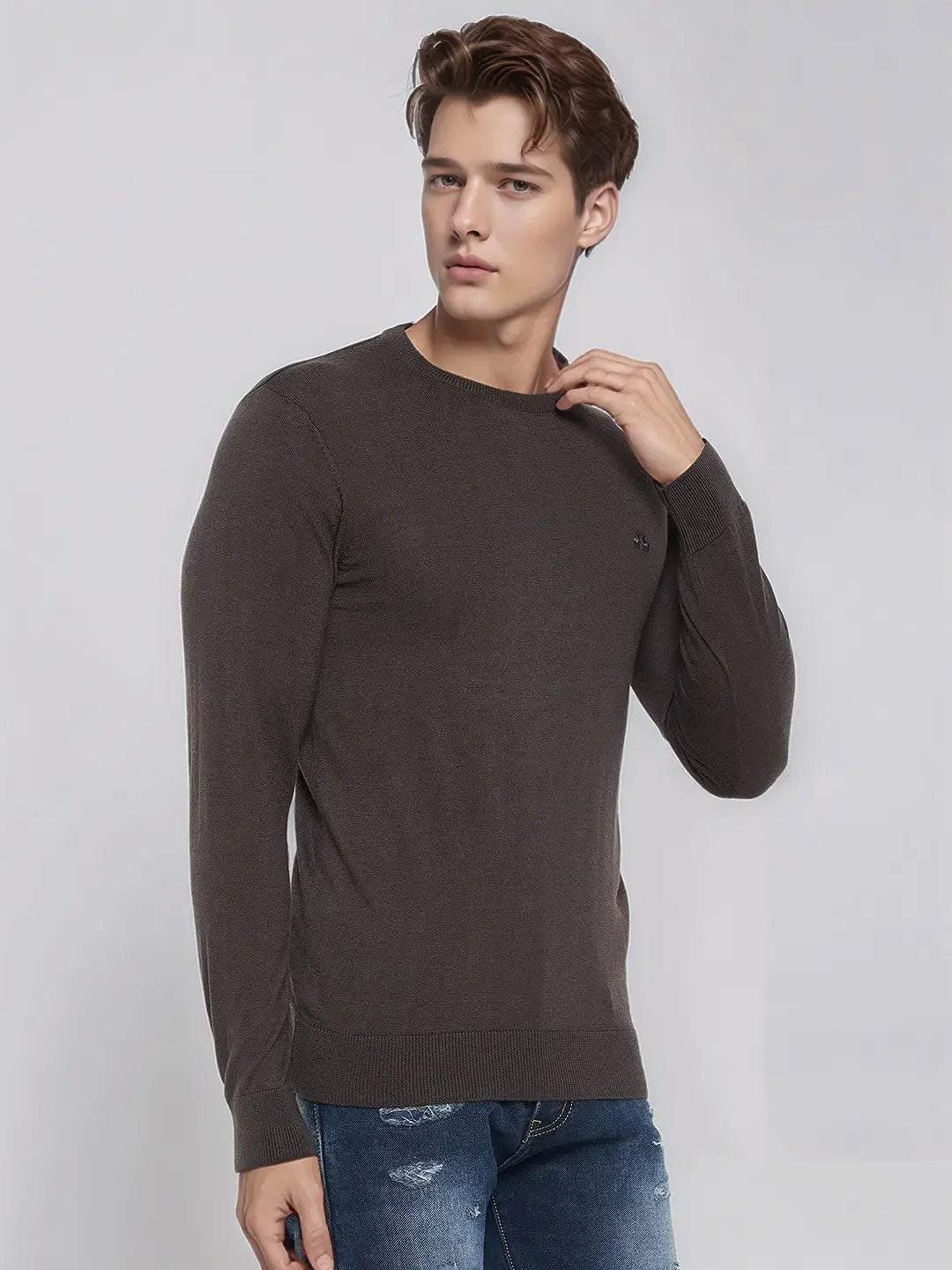 Young man wears 98degreenorth Men’s Charcoal Merino Wool Sweater, perfect for office or evening, against a gray backdrop.