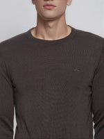 A man wears a 98degreenorth charcoal merino wool round neck sweater—minimalist, elegant winter knitwear.