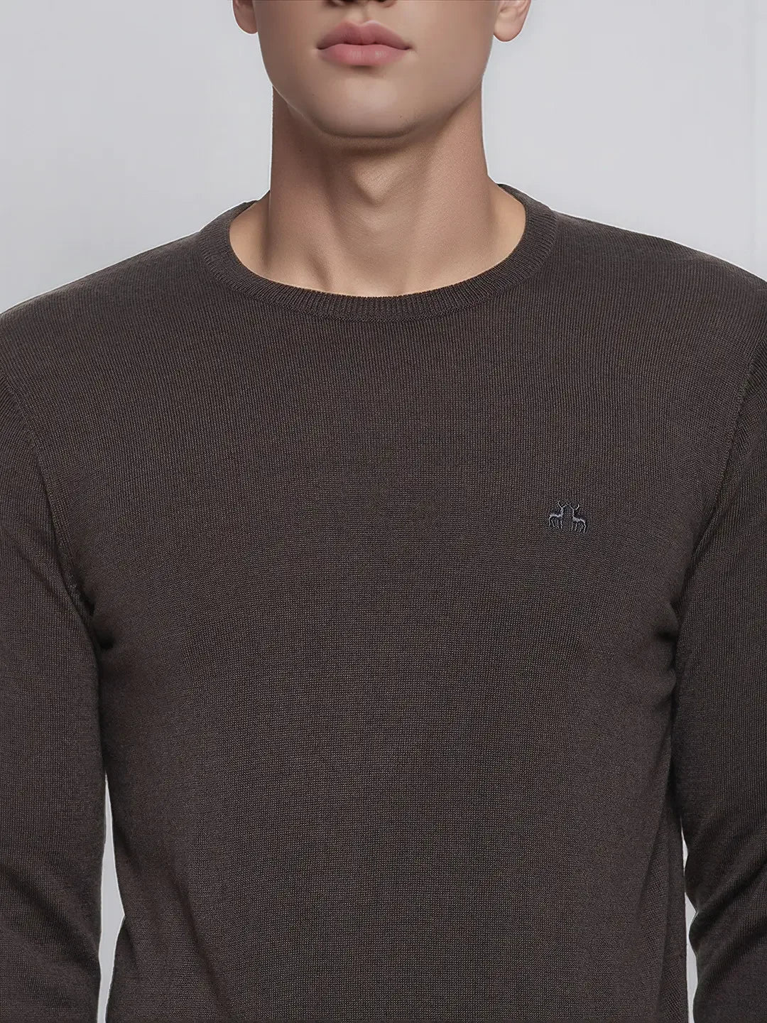 A man wears a 98degreenorth charcoal merino wool round neck sweater—minimalist, elegant winter knitwear.