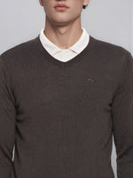 A man in a 98degreenorth charcoal Merino wool V-neck sweater over a white shirt, shown shoulders to lips.