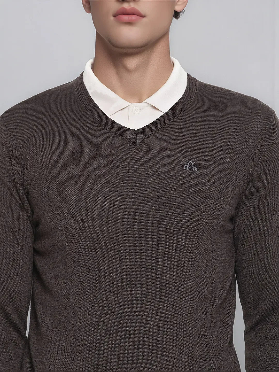 A man in a 98degreenorth charcoal Merino wool V-neck sweater over a white shirt, shown shoulders to lips.
