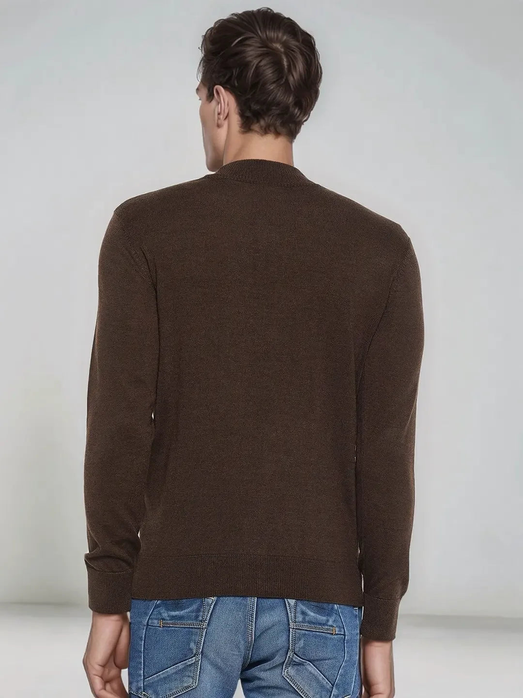 Man wears 98degreenorth Men’s Coffee Merino Wool Turtle Neck Sweater, back turned, paired with blue jeans.