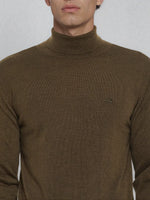 Man in 98degreenorth Coffee Merino Wool Turtle Neck Sweater, shown from shoulders up with small logo.