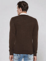 A man wears the 98degreenorth Men’s Coffee Merino Wool V-Neck Sweater, shown from the back on a light background.