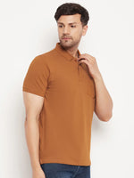Man in 98degreenorth Men’s Copper Polo—Pure Cotton Pique with Chest Pocket—wears blue jeans, standing sideways.