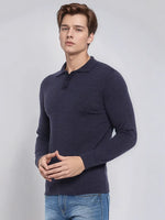 A man models the 98degreenorth Men’s Dark Denim Merino Wool Polo Neck Sweater against a plain light background.